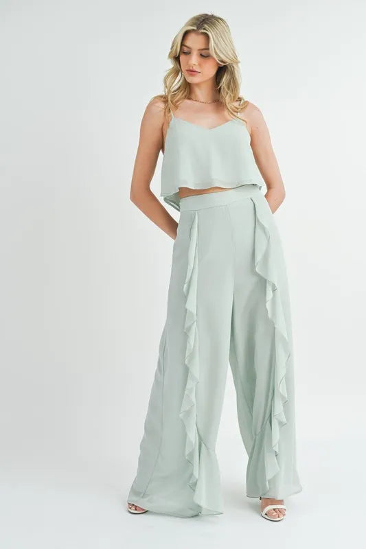 blonde model in two piece tank top and pant pale green outfit