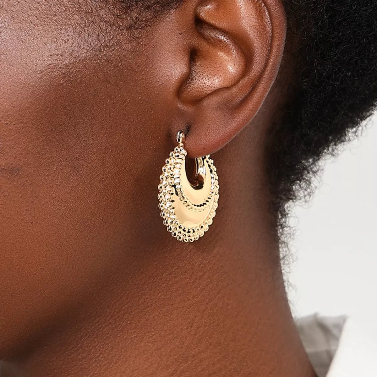 beautiful gold earring side view of female model side hair up