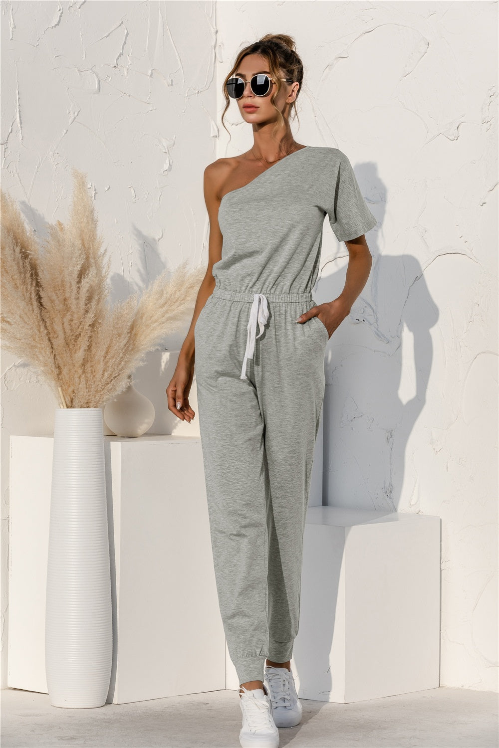 Bella Trendsi single shoulder short sleeve jumpsuit featuring a stylish design with a relaxed fit and trendy silhouette.