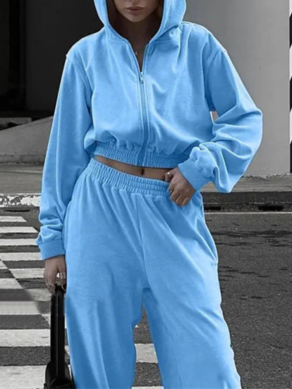 BELLA BLA zip-up hoodie and pocketed pants set, casual athleticwear, displayed on a hanger with a neutral background.