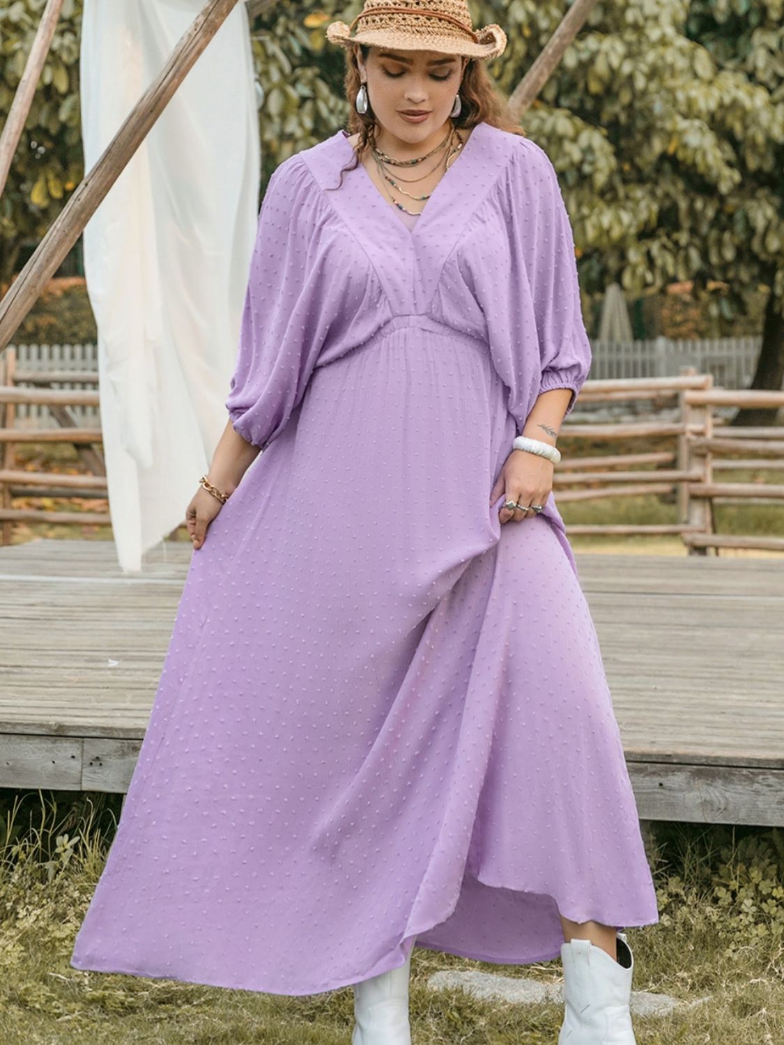 Plus size BELLA Swiss Dot V-Neck midi dress with long sleeves and a flowing silhouette, featuring a charming dotted pattern.