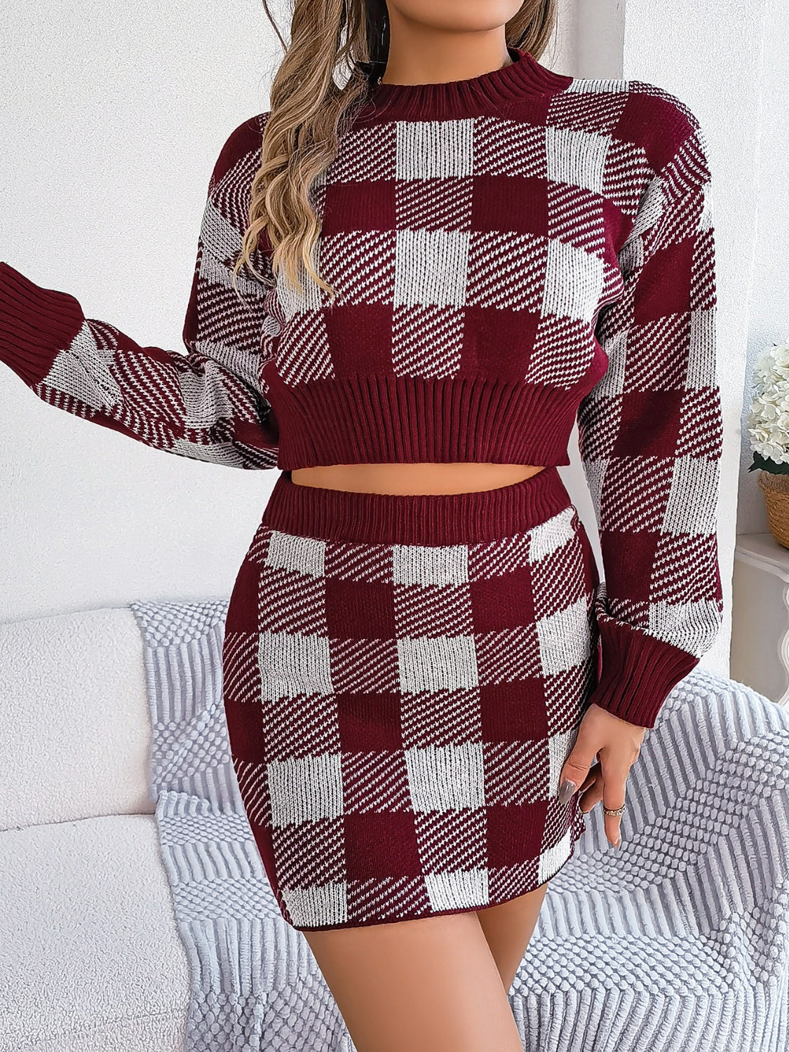 BELLA plaid round neck top and skirt sweater set featuring a classic red and black checkered pattern, cozy knit fabric, and stylish fit.