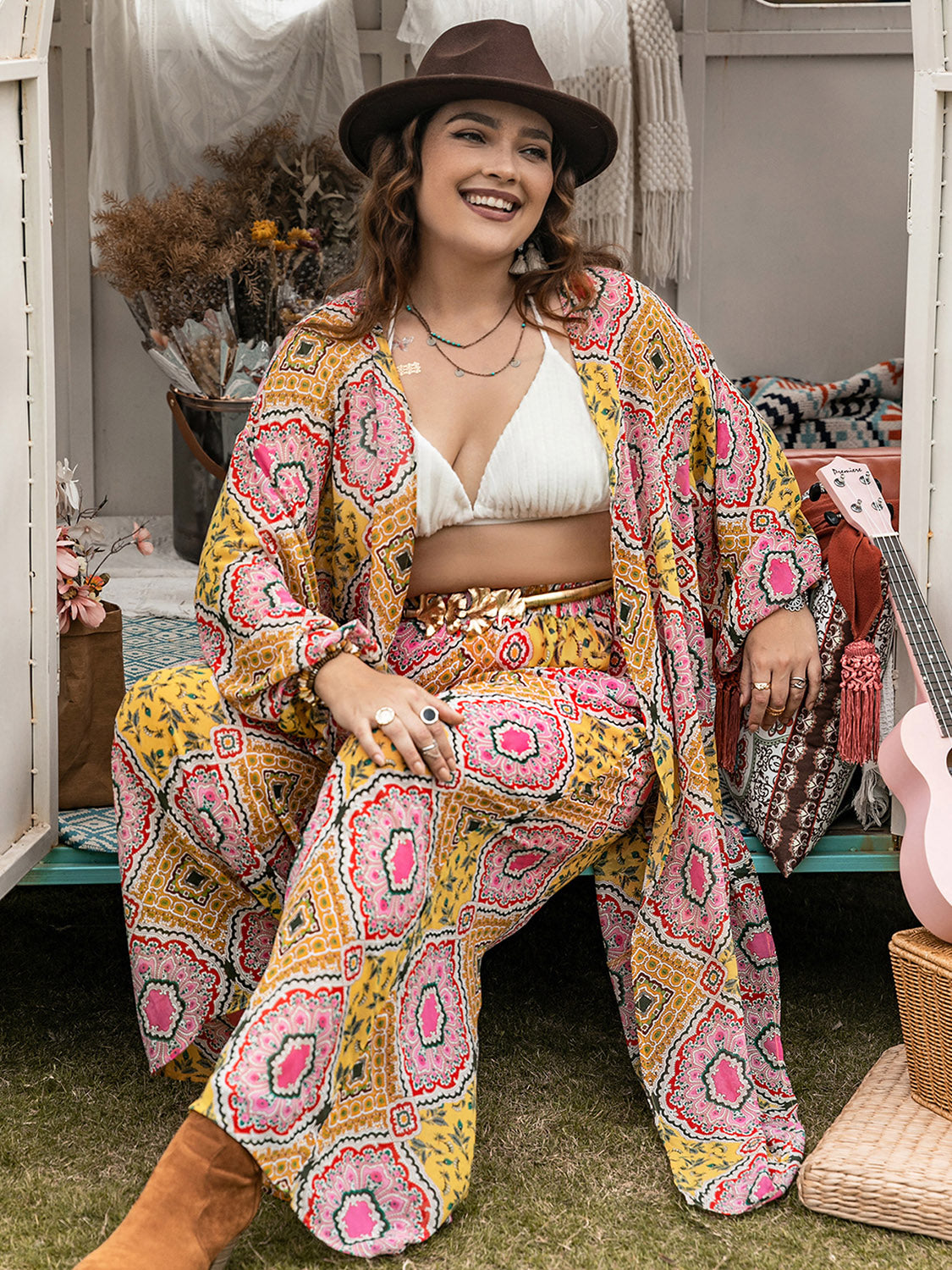 Plus size printed open front cover-up and pants set by BELLA, featuring colorful floral pattern, lightweight fabric, and relaxed fit.