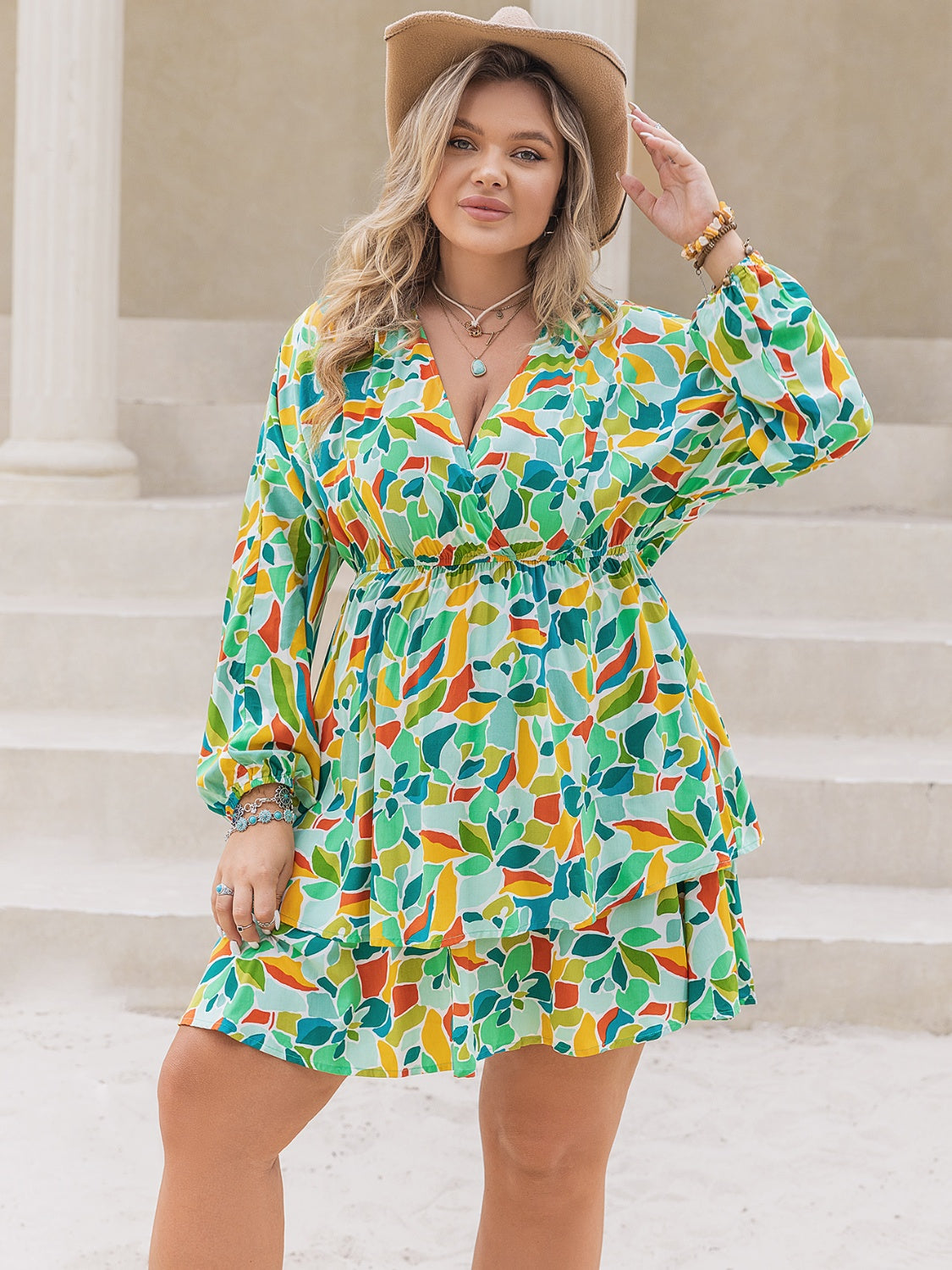 Plus size printed surplice long sleeve mini dress by BELLA, featuring a stylish pattern and flattering fit.