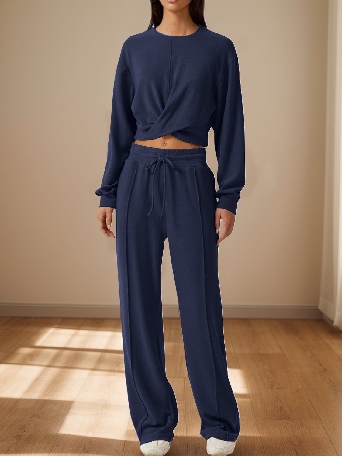 BELLA Trendsi crisscross round neck top and drawstring pants set featuring a stylish, coordinated outfit in soft fabric.