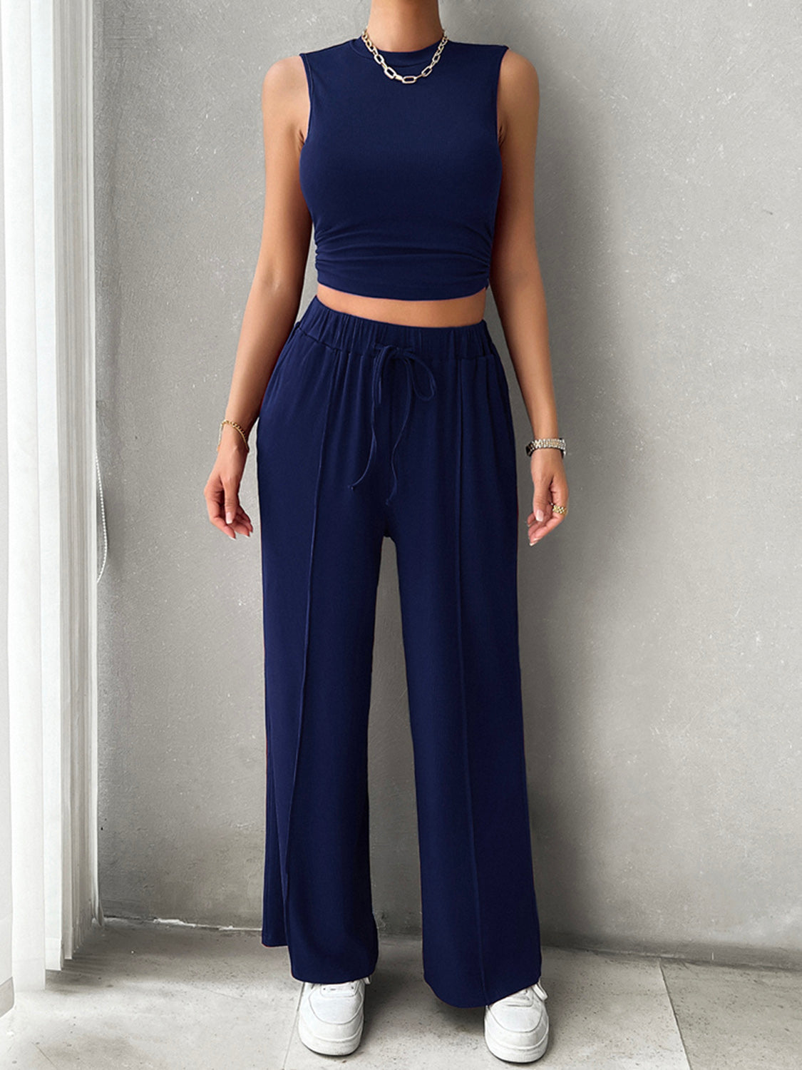 BELLA Trendsi mock neck sleeveless top and drawstring pants set in neutral fabric, displayed on a hanger.