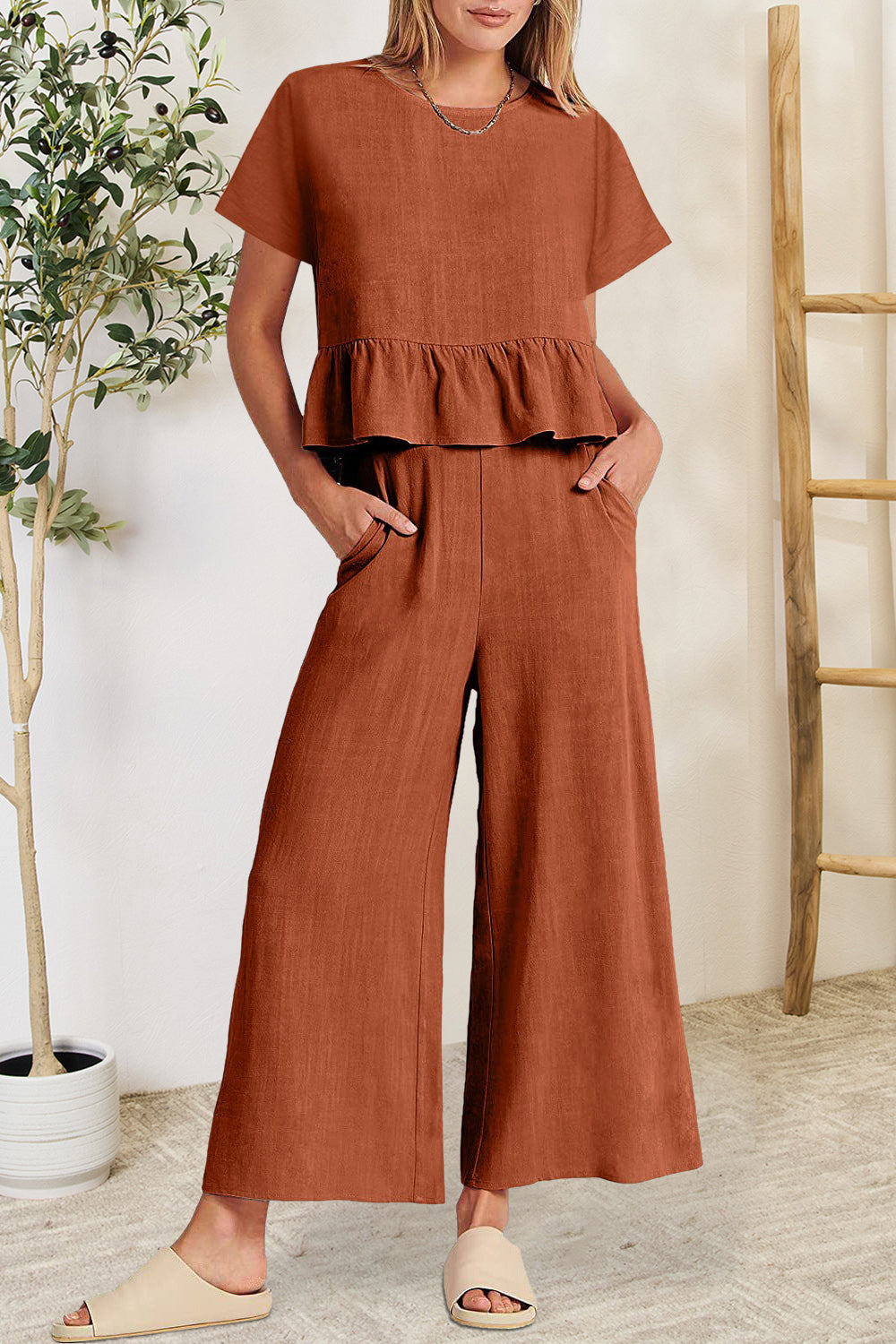 BELLA trendsi peplum round neck short sleeve top and matching pants set displayed on a model in a casual indoor setting.