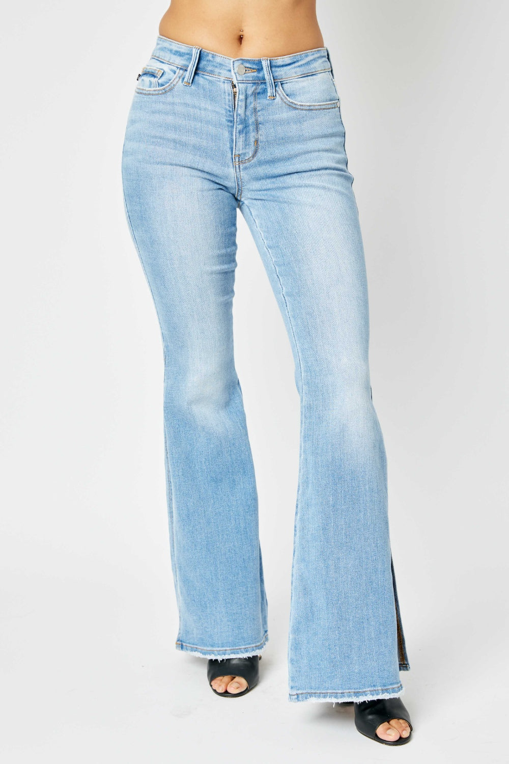 BELLA Judy Blue mid-rise raw hem slit flare jeans with trendy distressed details and a classic denim look.