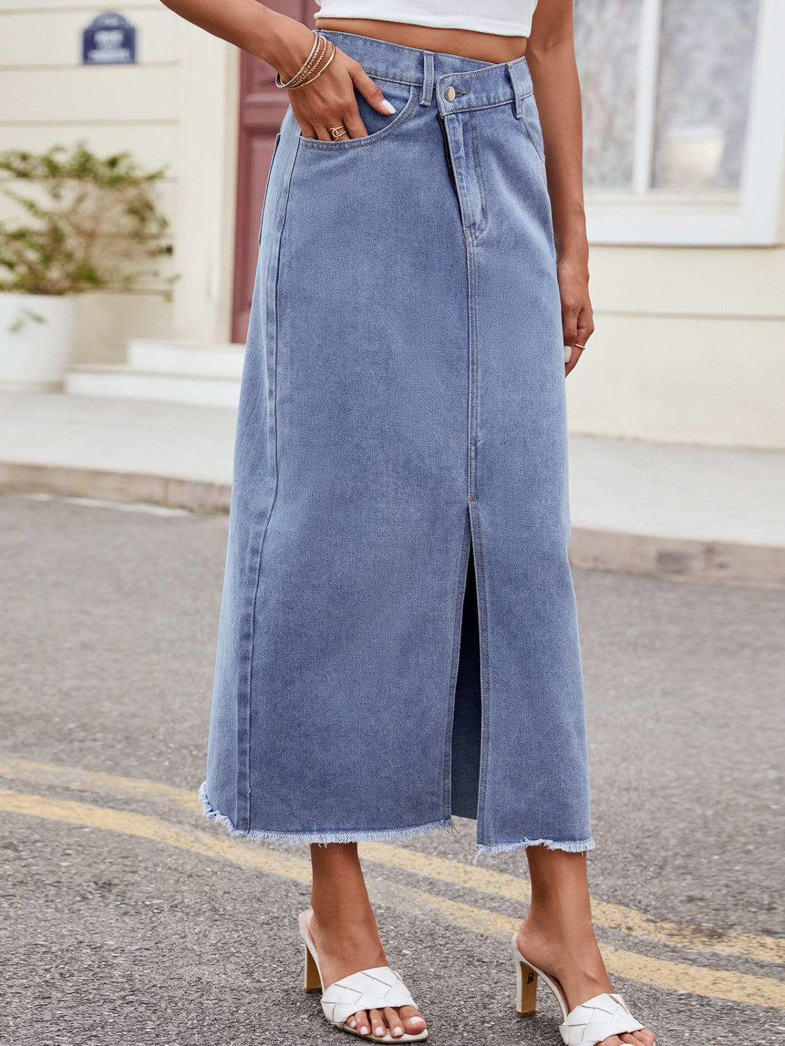 BELLA Trendsi asymmetrical denim skirt with a front slit and high waist, styled with casual tops and accessories.