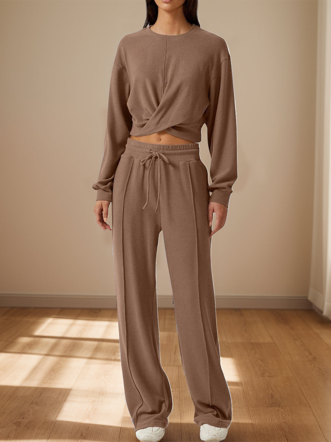 BELLA Trendsi crisscross round neck top and drawstring pants set displayed on a model, featuring a stylish and comfortable matching outfit.