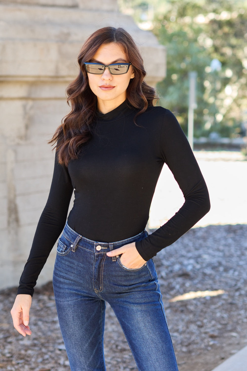 BELLA trendsi full size mock neck long sleeve bodysuit displayed on a model, featuring a fitted design and classic black color.