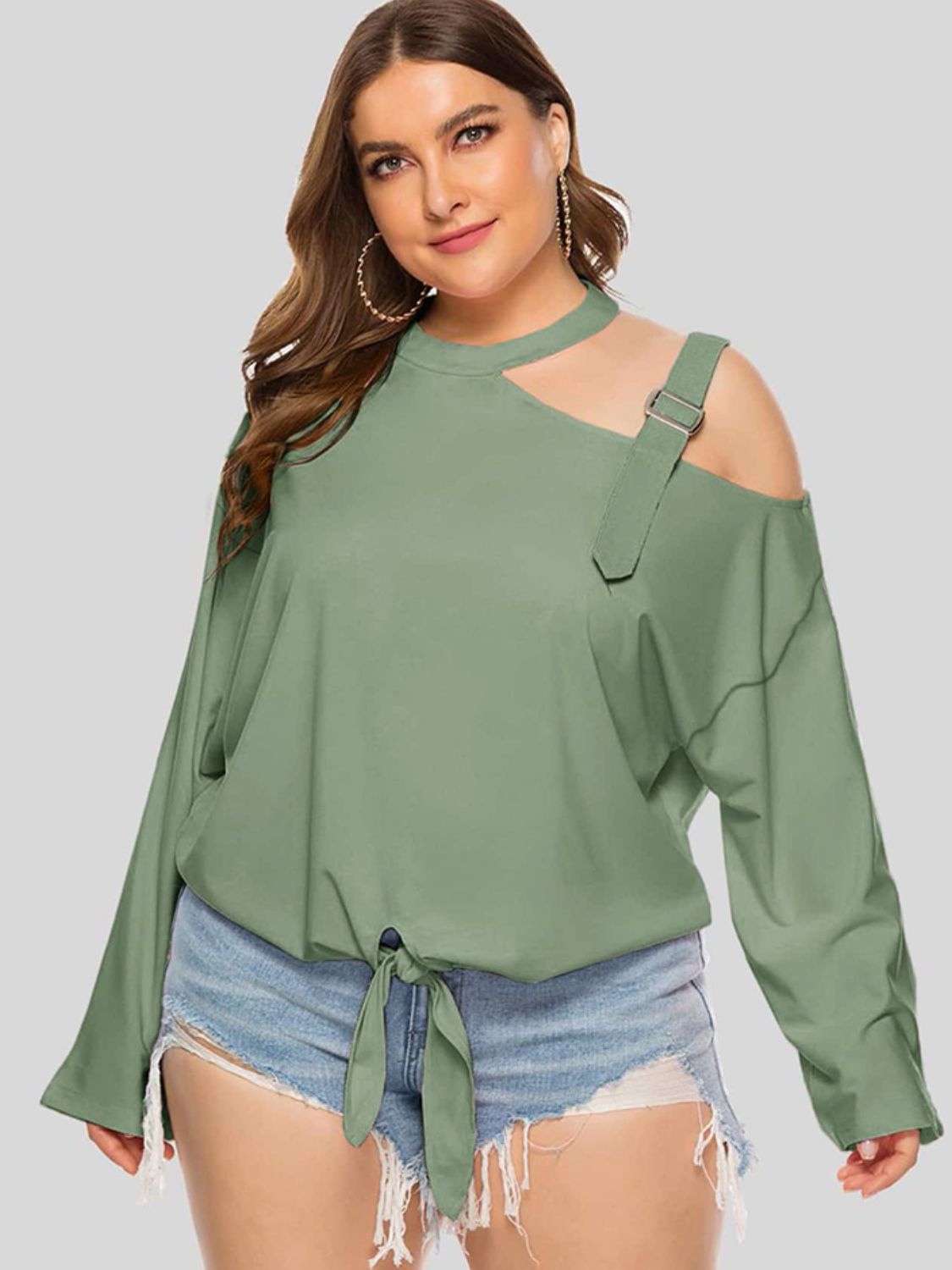Plus size cold-shoulder tied top by BELLA featuring trendy style and relaxed fit, with tied neckline and shoulder cutouts.