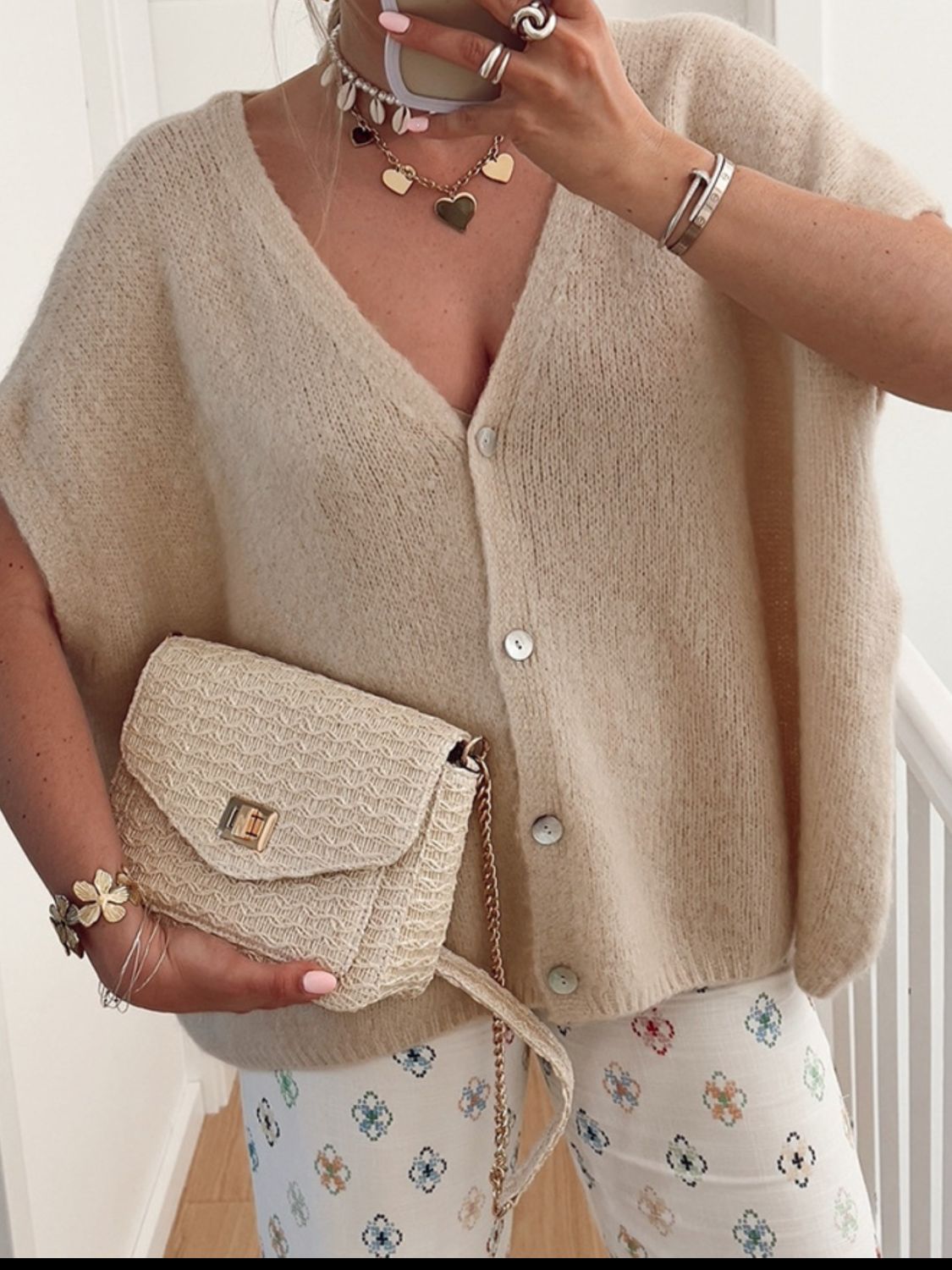 BELLA Trendsi V-neck button-up short sleeve cardigan laid flat, showcasing beige knit fabric and classic design.