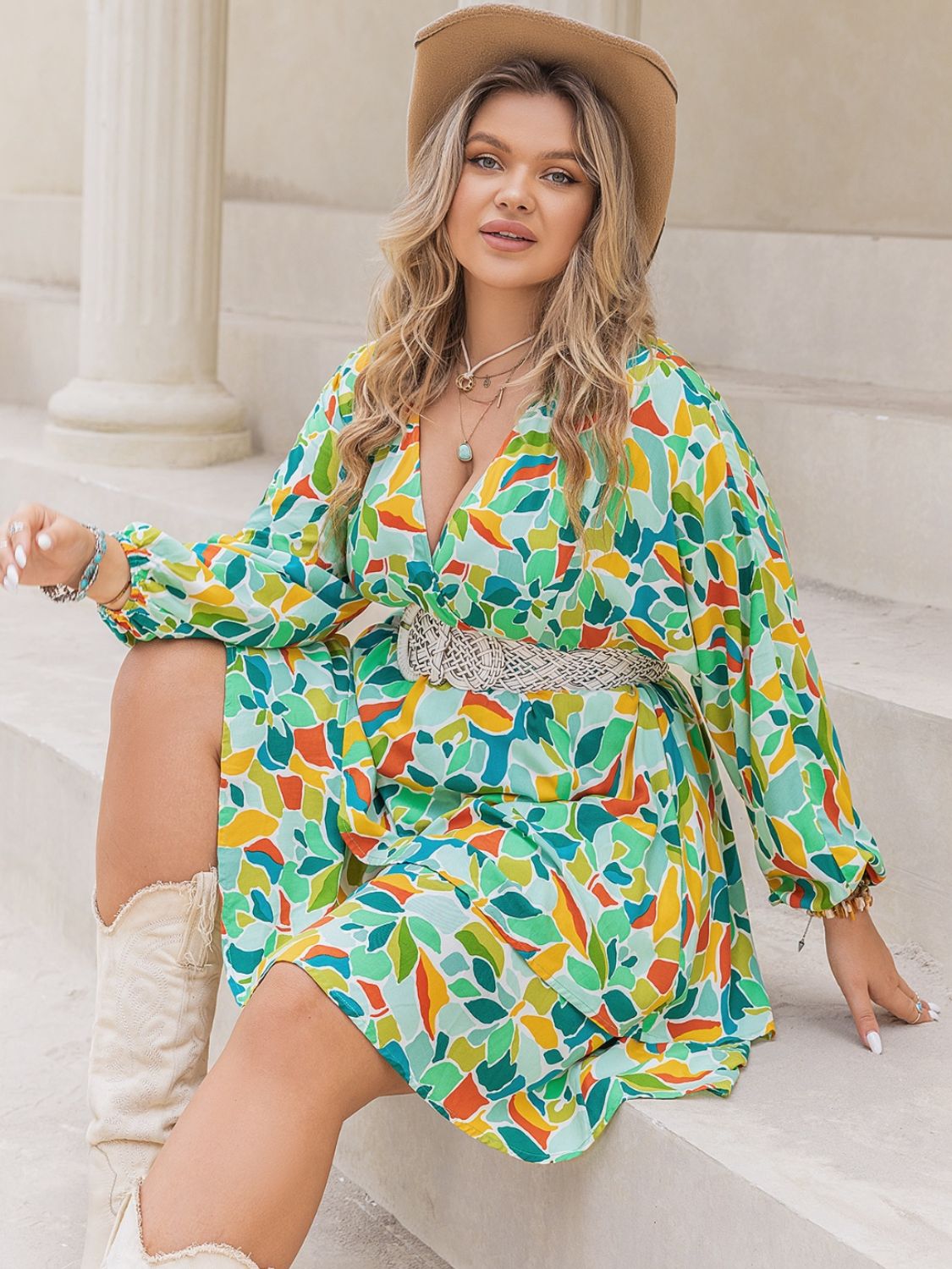 Plus size BELLA printed surplice long sleeve mini dress, stylish and fitted with a floral pattern, perfect for casual or dressy occasions.