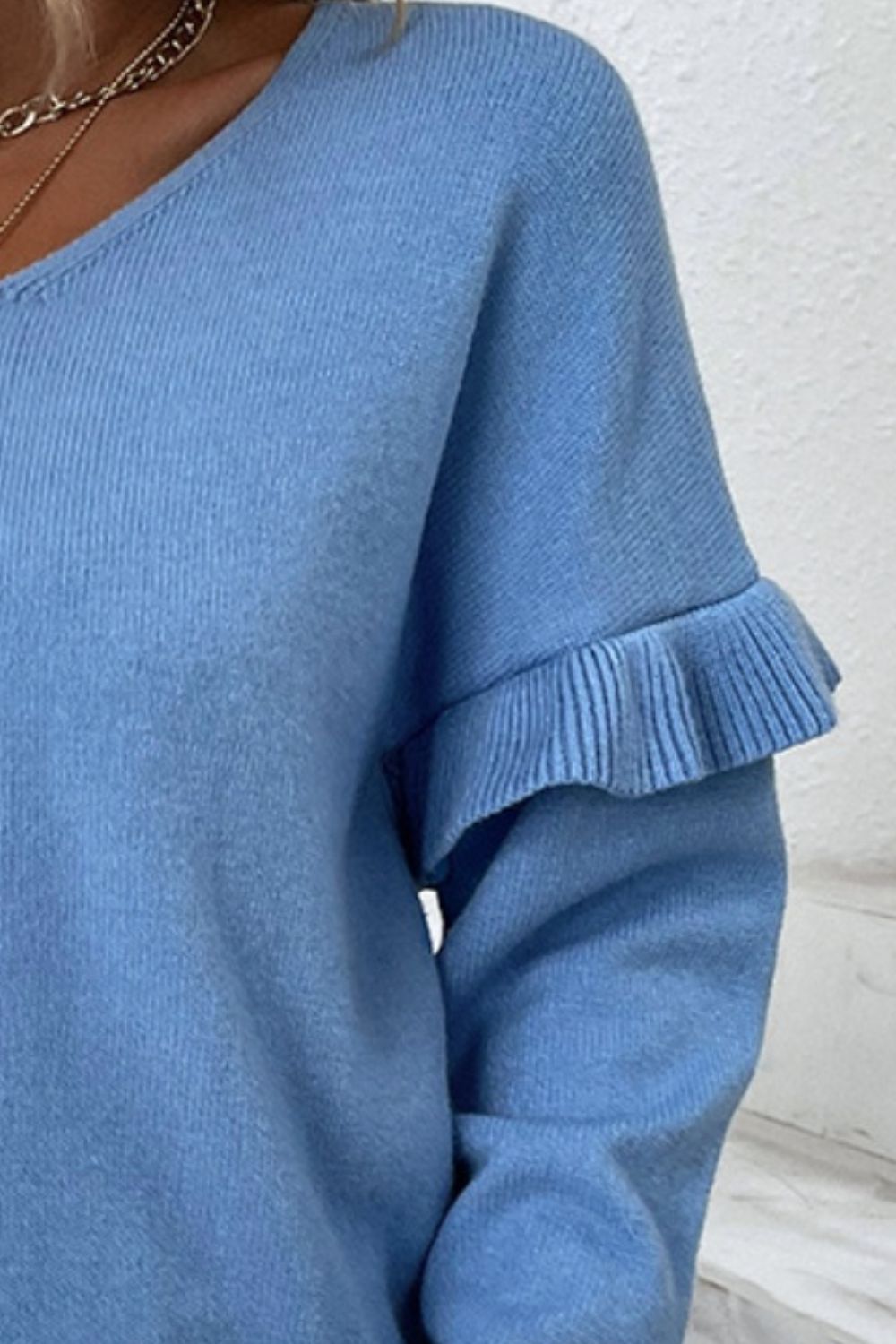 BELLA V-neck ruffle trim long sleeve sweater, trendy knit top with feminine ruffle accents and a comfortable fit.