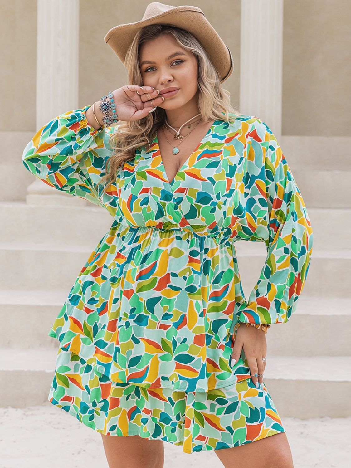 Plus size printed surplice long sleeve mini dress by BELLA, featuring a stylish pattern and flattering fit for trendy fashion.