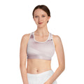 Pale pink abstract print sports bra by BELLA, featuring a stylish and supportive design for active wear.