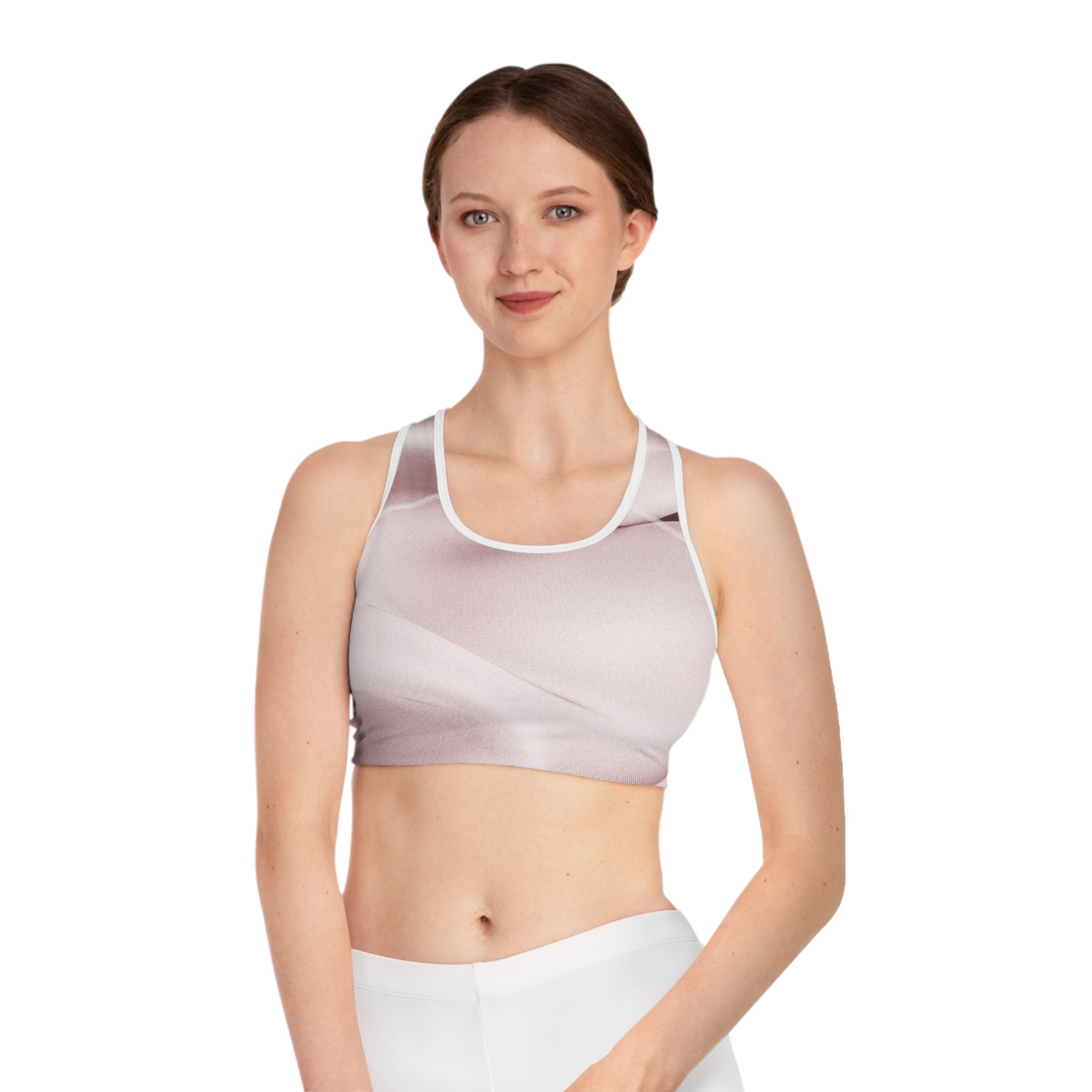 Pale pink abstract print sports bra by BELLA, featuring a stylish and supportive design for active wear.