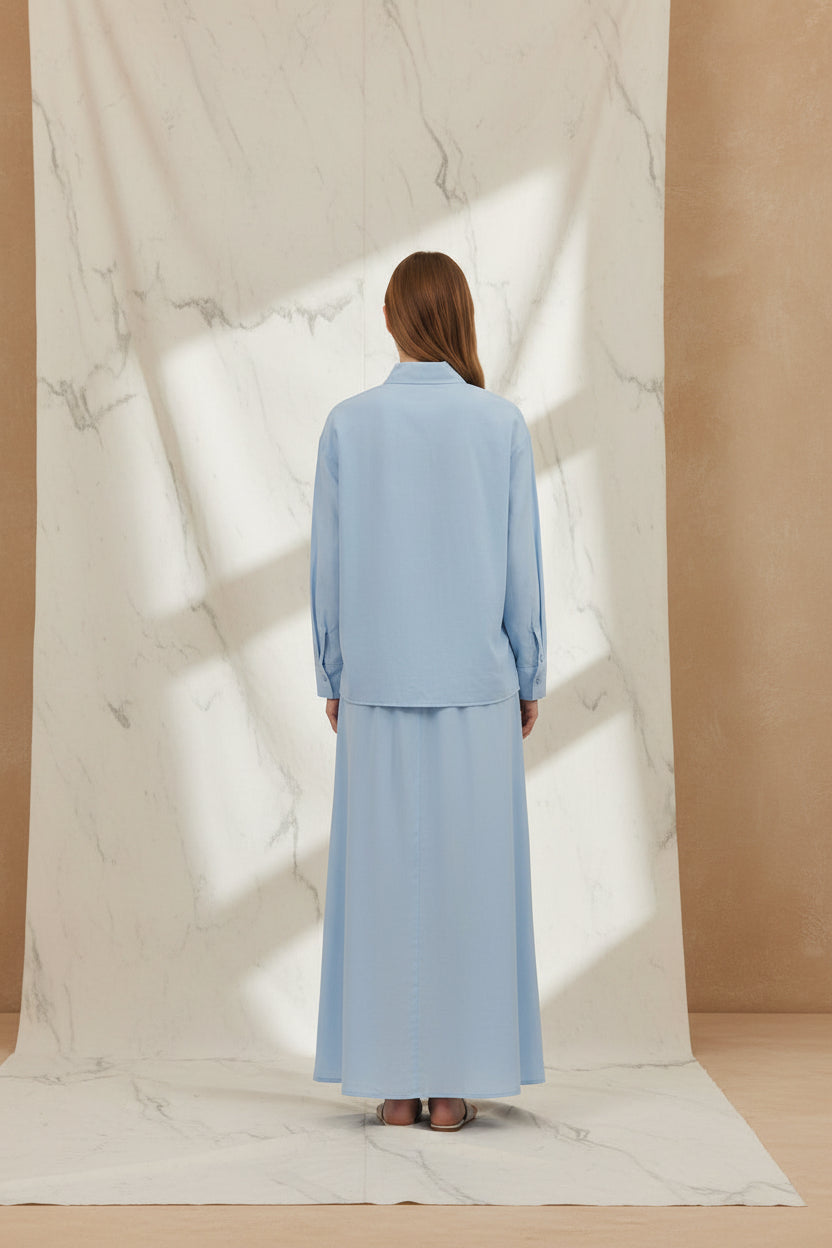 Light blue outfit with a jacket and skirt on a white background