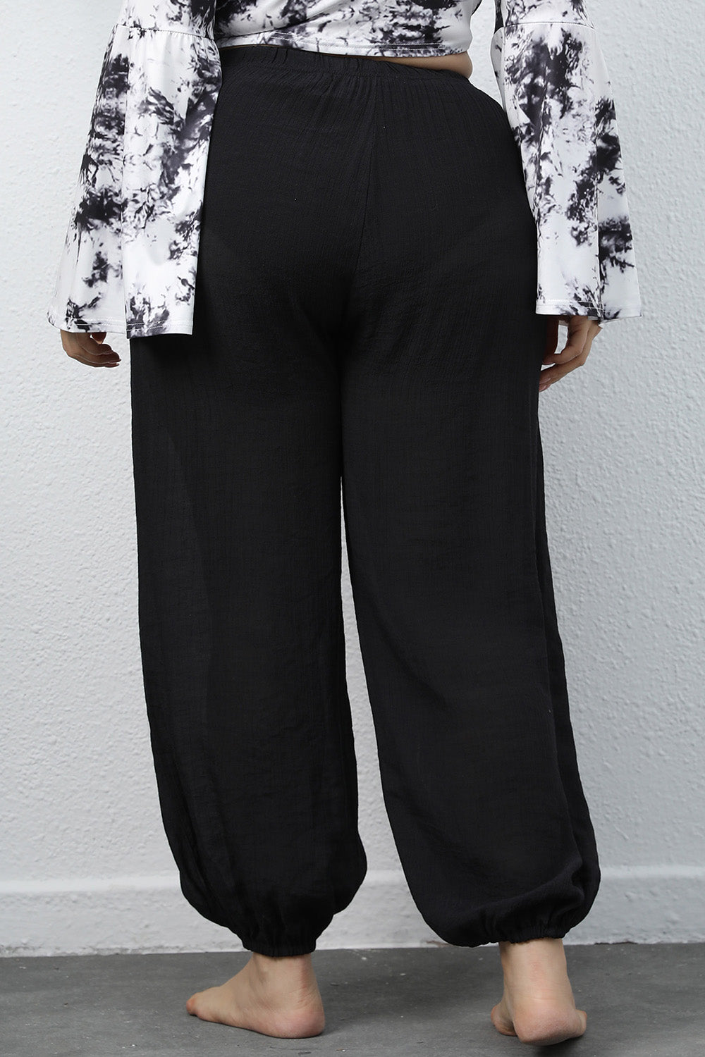 Plus size BELLA drawstring jogger pants featuring comfortable fit and casual style, shown in a relaxed pose.