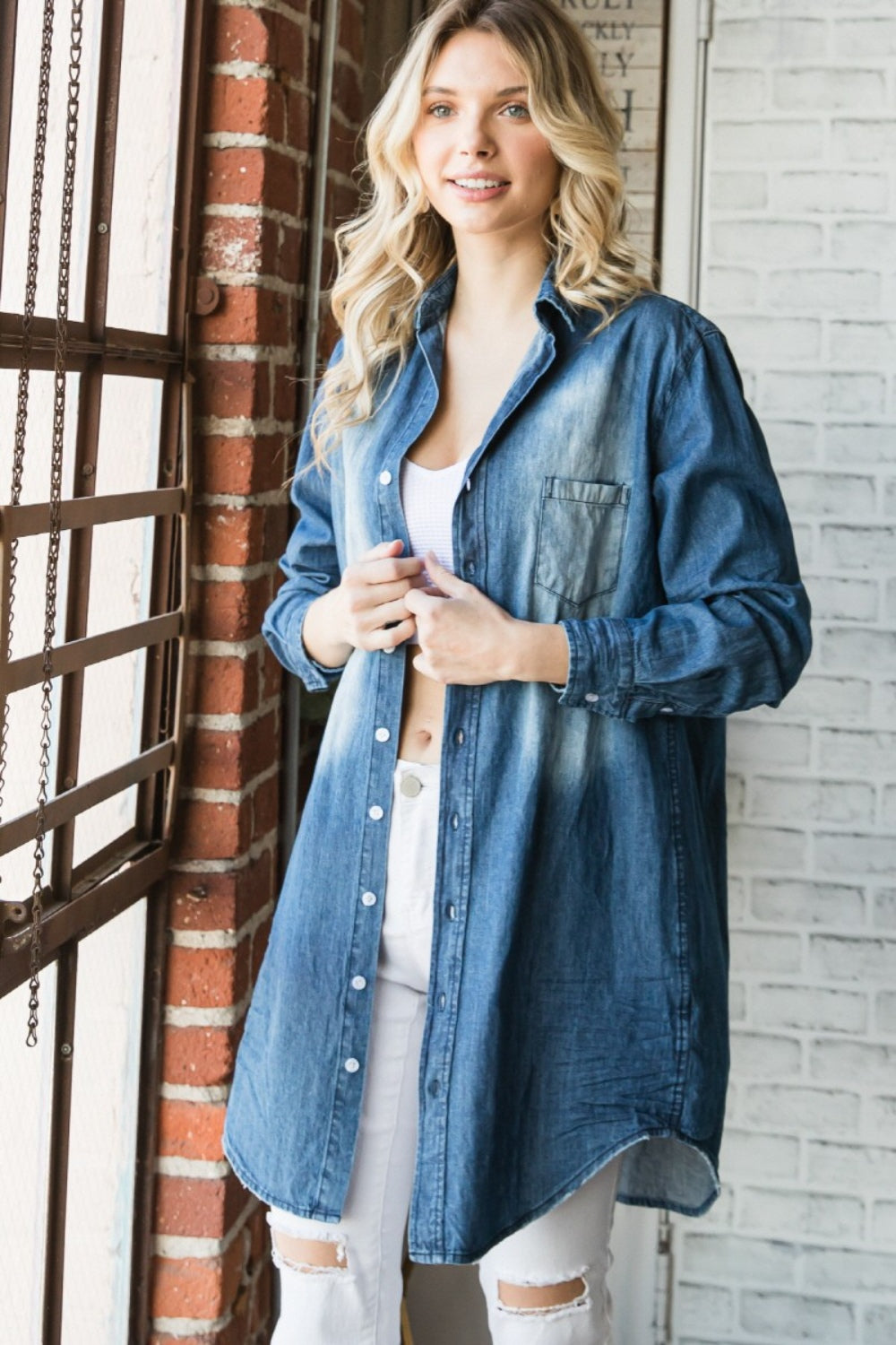 BELLA Veveret pocketed washed denim shirt with button-up front and long sleeves, displayed on a hanger.