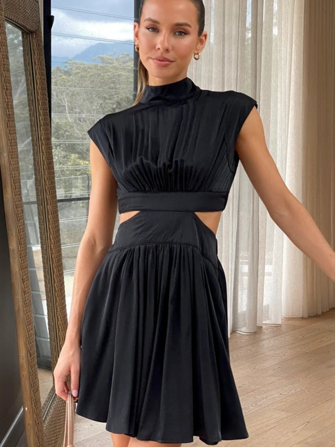 BELLA BLA Cutout Ruched Mock Neck Mini Dress from Trendsi featuring a fitted silhouette and stylish ruching detail.