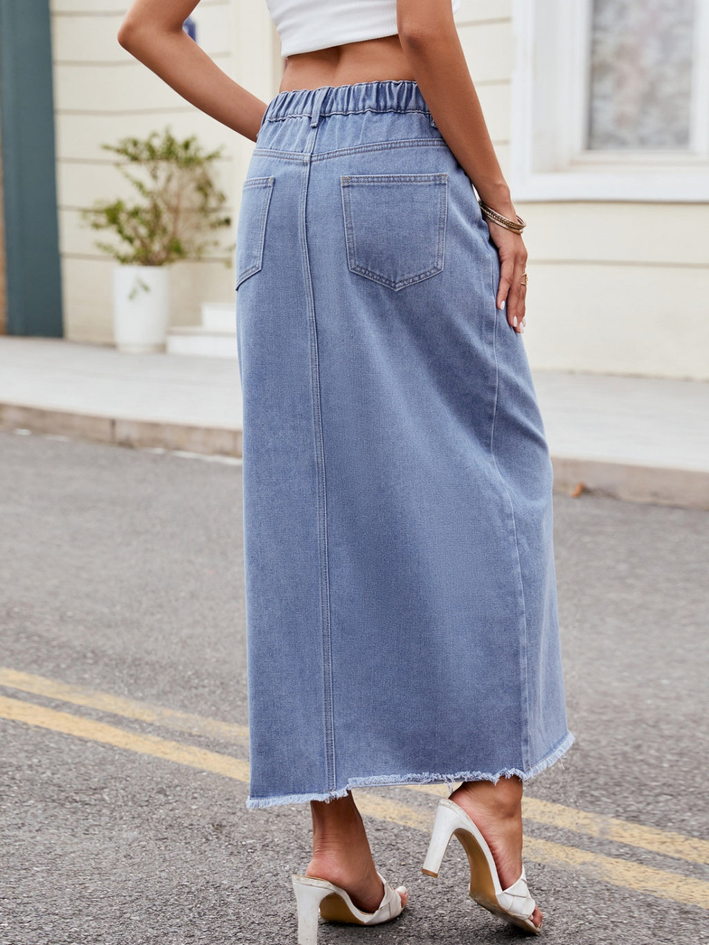 BELLA trendsi slit asymmetrical waist denim skirt featuring a stylish design and a high slit on a model.