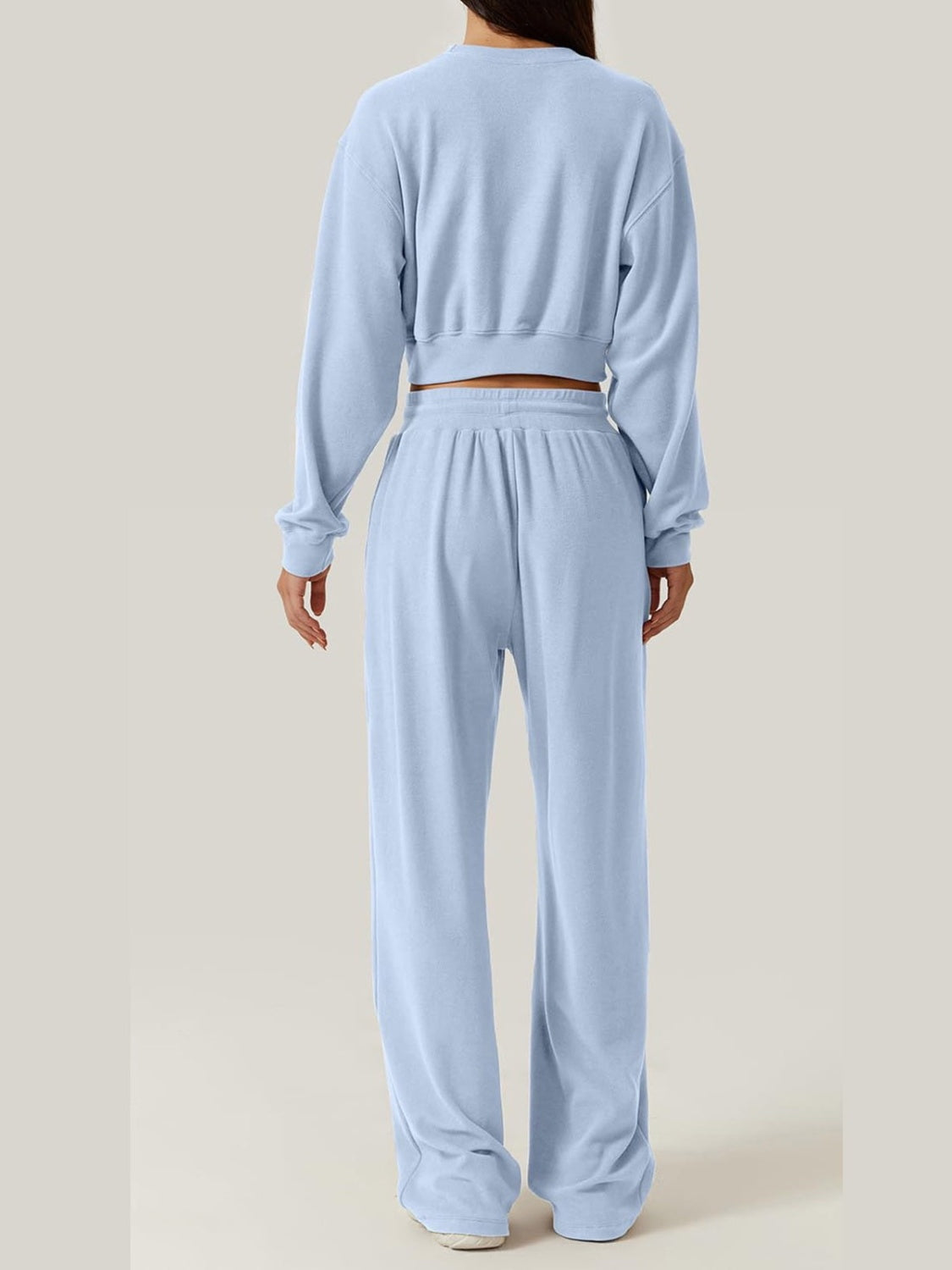 BELLA crisscross round neck top and drawstring pants set, trendy casual outfit, shown in a stylish, coordinated ensemble.