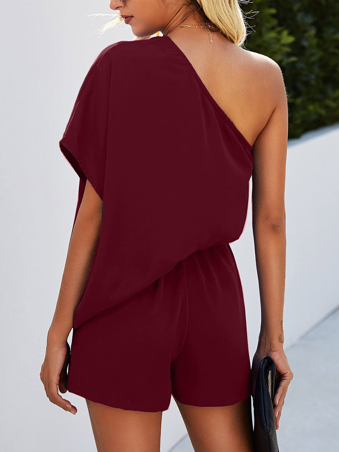 BELLA trendsi single shoulder batwing sleeve romper, stylish women's jumpsuit with asymmetrical sleeve detail, black fabric.