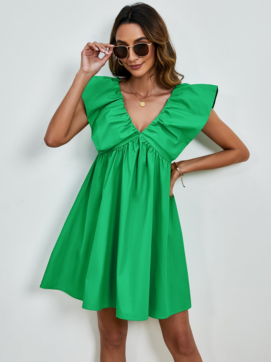 BELLA V-neck cap sleeve mini dress from Trendsi, featuring a fitted silhouette and stylish design, perfect for casual or semi-formal wear.