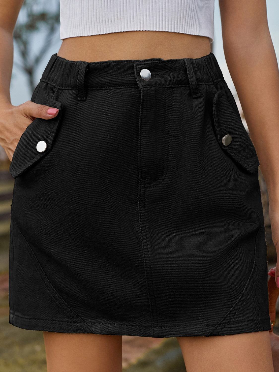 BELLA trendy mini denim skirt with front pockets and button details, casual style perfect for everyday wear.