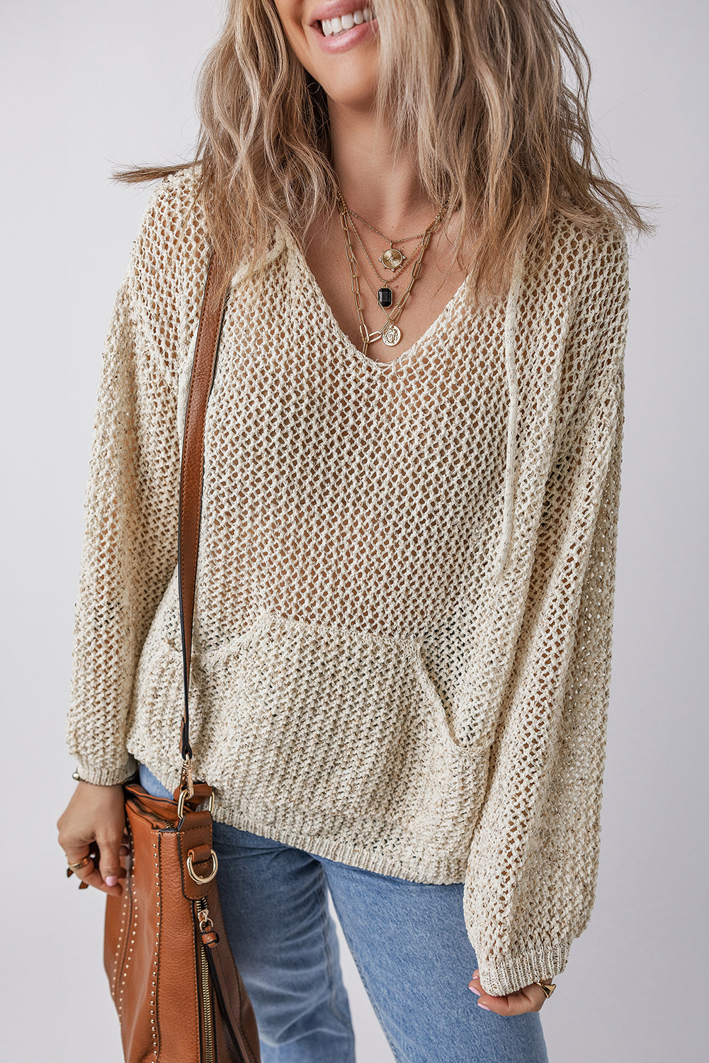 BELLA openwork dropped shoulder hooded knit top featuring a stylish, lightweight design with an open pattern and relaxed fit.