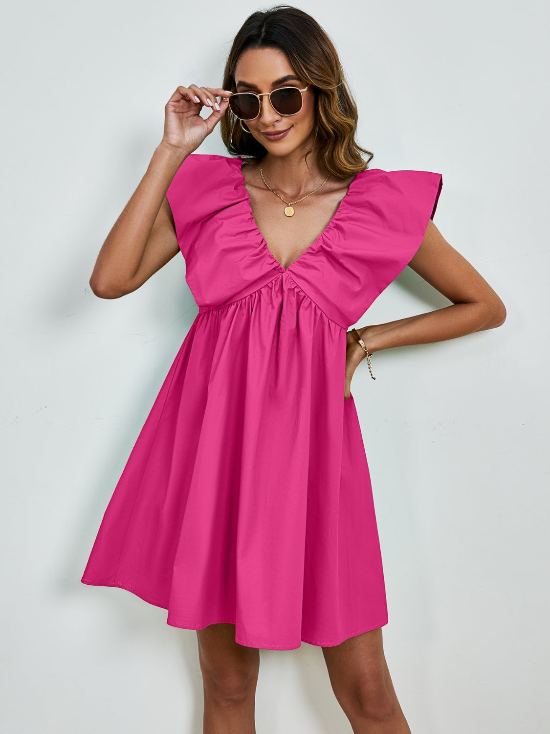 BELLA V-neck cap sleeve mini dress displayed on a hanger, featuring a sleek and stylish design perfect for summer occasions.