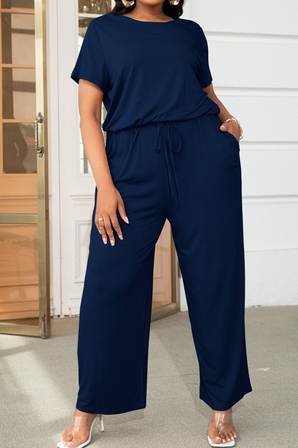 Plus size BELLA trendsi short sleeve jumpsuit with drawstring waist, casual and comfortable fit, front view on model