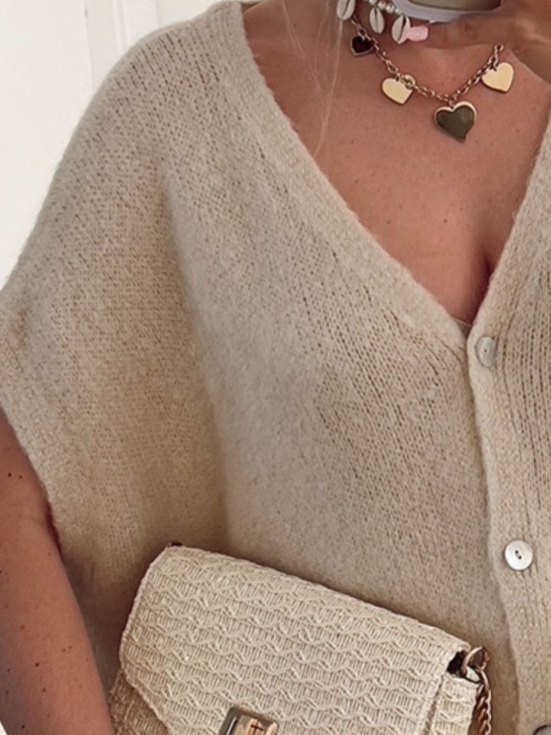 BELLA V-neck button-up short sleeve cardigan from Trendsi, featuring a classic design with buttons and a V-neck style.