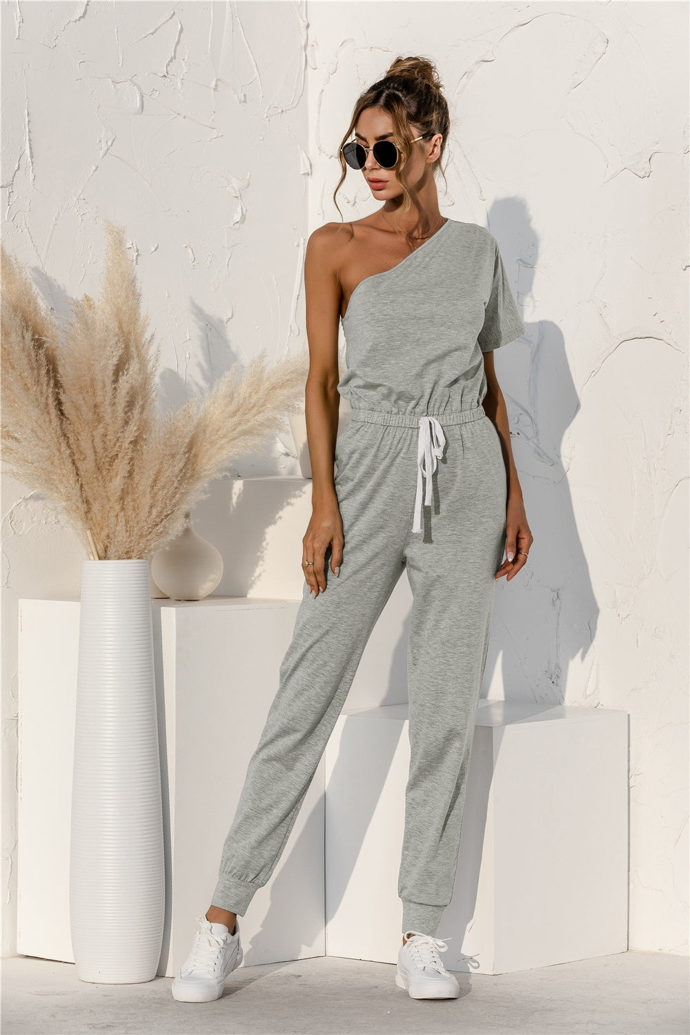 BELLA Trendsi single shoulder short sleeve jumpsuit in black, featuring a fitted silhouette and stylish design.