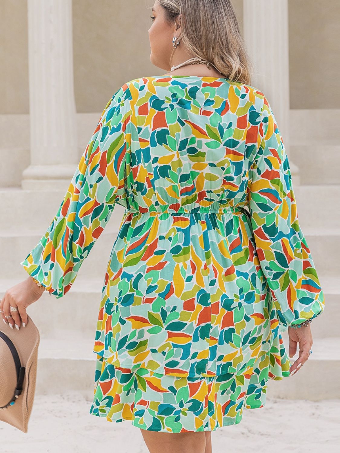 Plus size BELLA printed surplice long sleeve mini dress, stylish and comfortable for casual or dressy occasions.