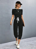 BELLA trendsi round neck short sleeve jumpsuit displayed on a hanger, showcasing its simple, stylish design and soft fabric.