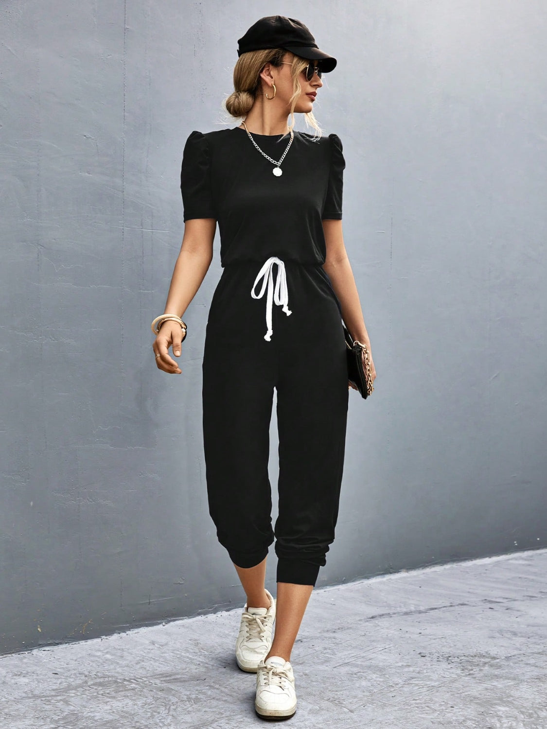 BELLA trendsi round neck short sleeve jumpsuit displayed on a hanger, showcasing its simple, stylish design and soft fabric.