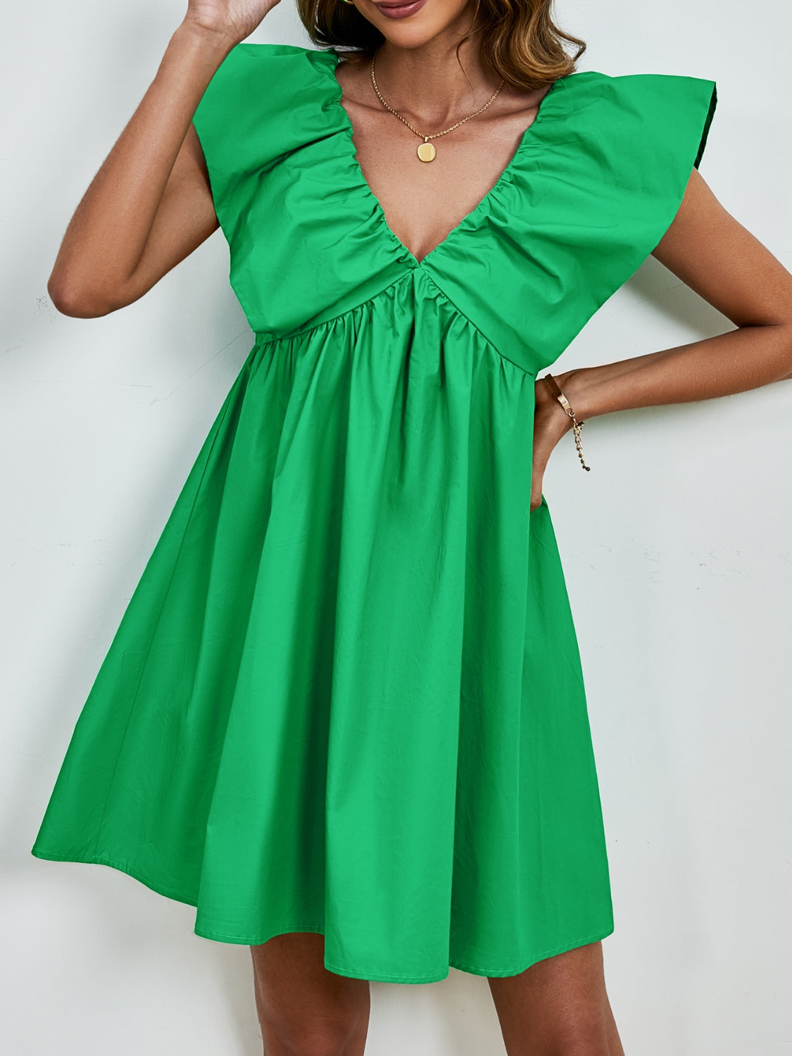 BELLA V-neck cap sleeve mini dress from Trendsi, featuring a stylish V-neckline and sleek cap sleeves in a flattering fit.