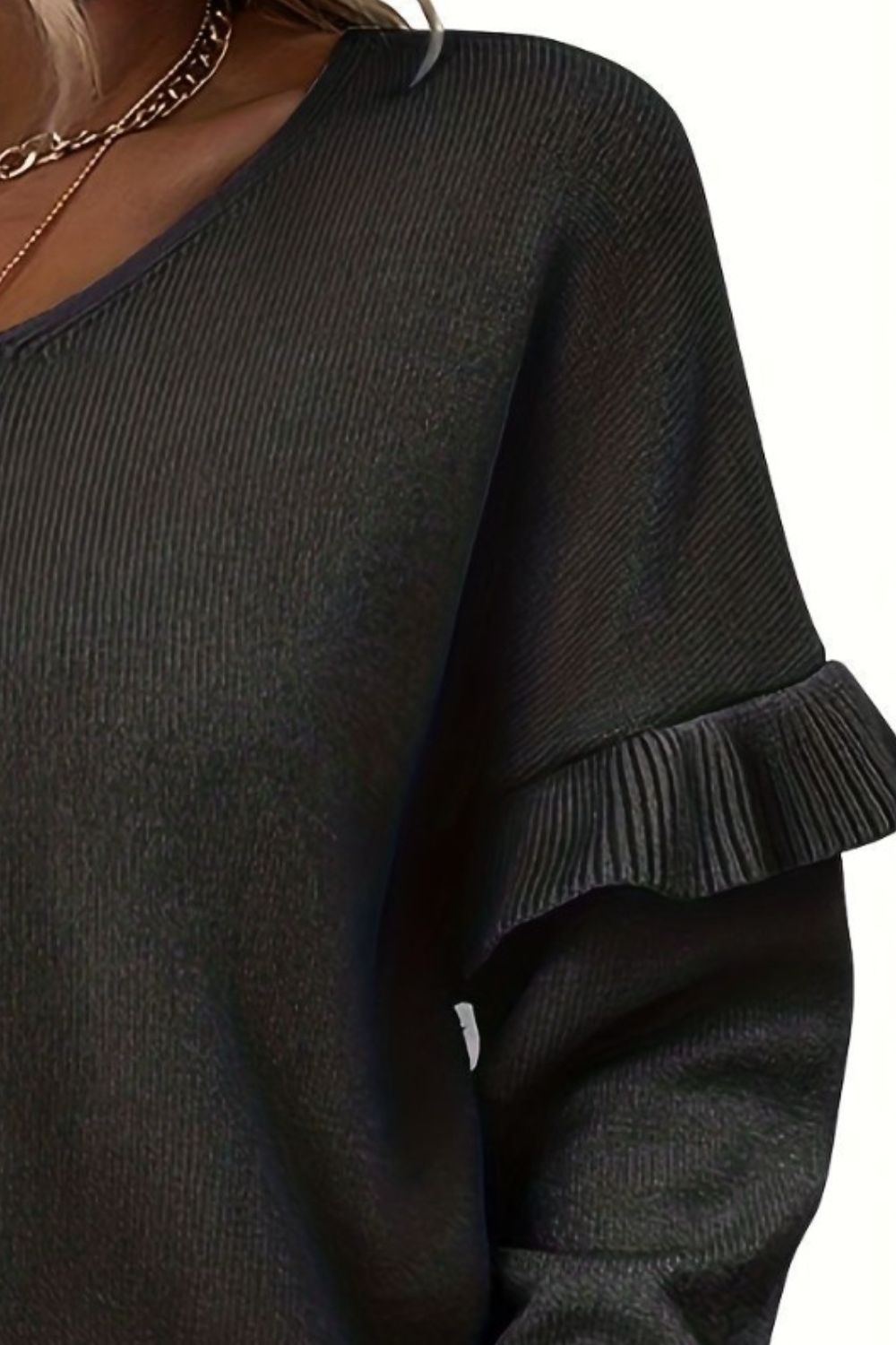 BELLA V-neck ruffle trim long sleeve sweater in soft knit fabric with delicate ruffle detailing on the neckline and sleeves.