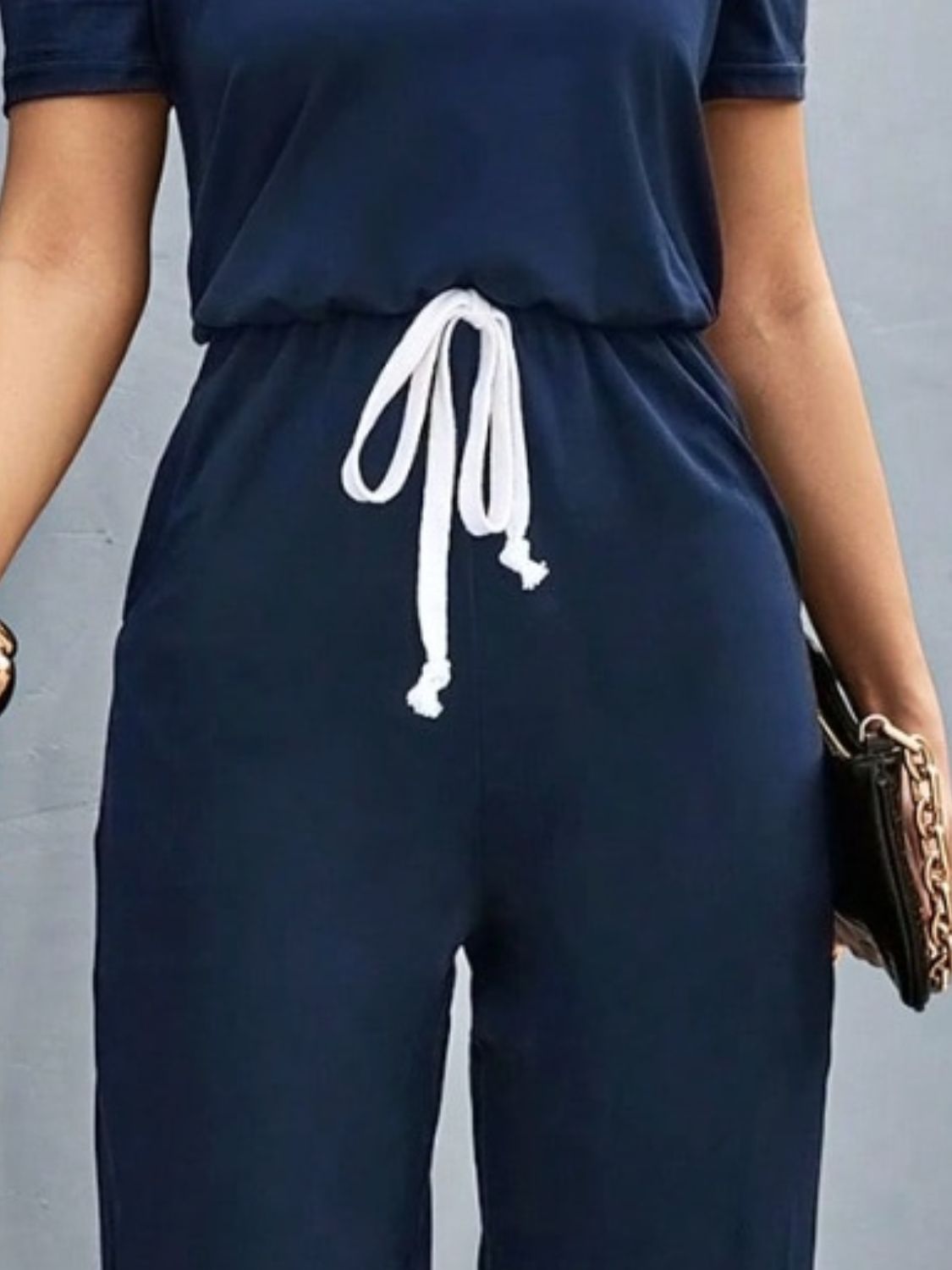 BELLA Trendsi short sleeve jumpsuit with round neckline, showcased in a casual, stylish outfit on a model.