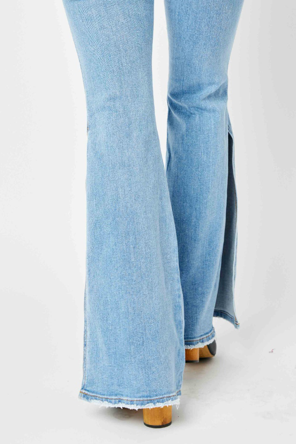 BELLA Judy Blue full-size mid-rise raw hem slit flare jeans, shown with distressed details and classic denim wash