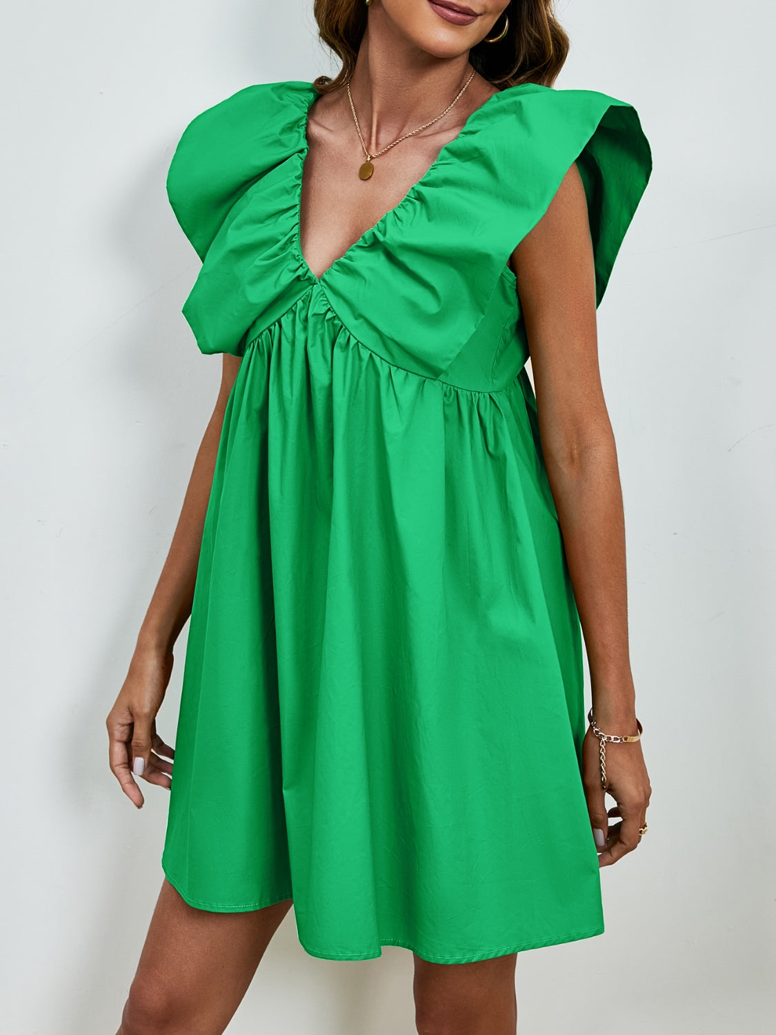 BELLA V-neck cap sleeve mini dress from Trendsi, featuring a stylish V-neckline and a fitted silhouette in a trendy design.