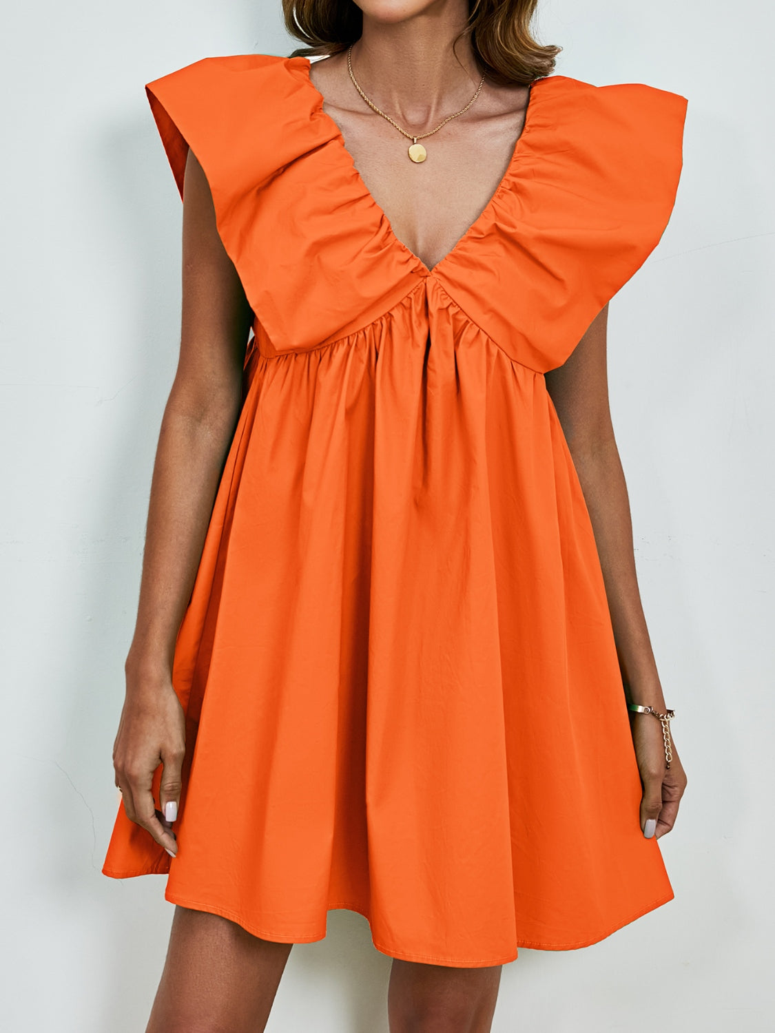 BELLA V-neck cap sleeve mini dress from Trendsi, featuring a fitted silhouette and stylish design for casual or semi-formal wear.