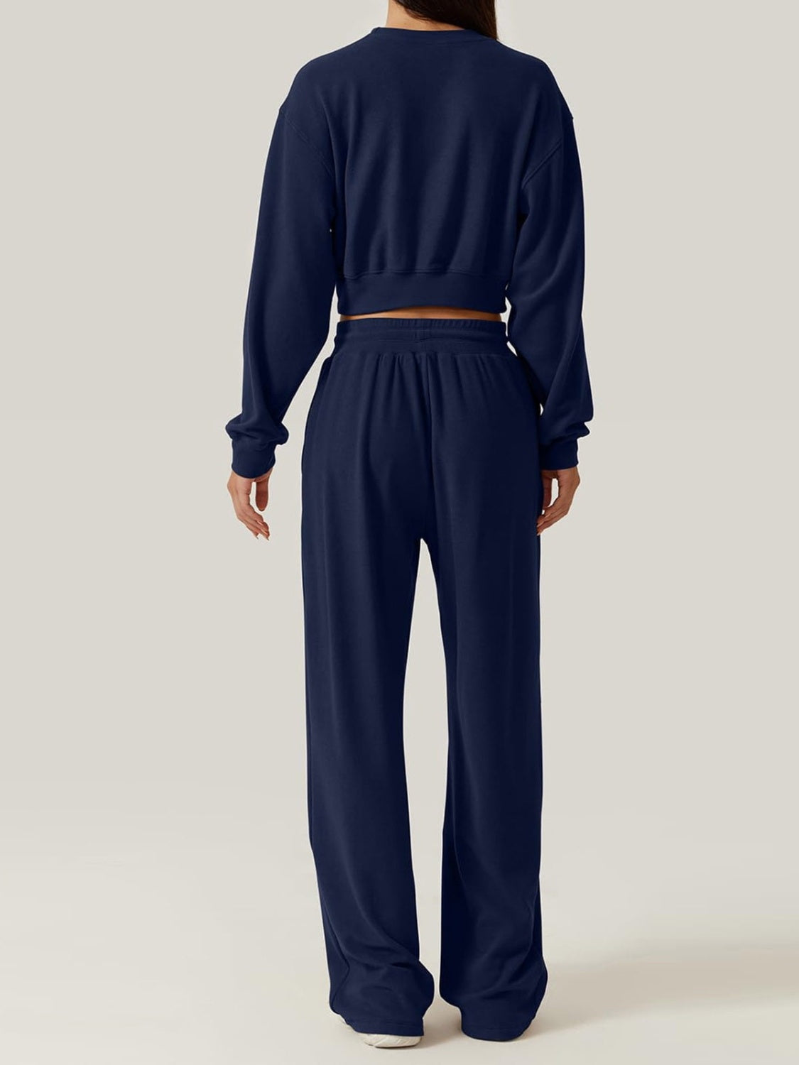 BELLA crisscross round neck top and drawstring pants set in trendy style, shown in a casual indoor setting.