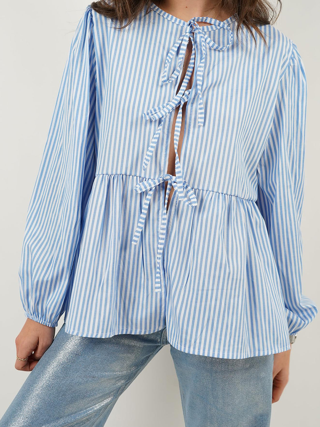 BELLA BLA Tied Round Neck Long Sleeve Blouse from trendsi, showcasing a stylish blouse with a tied neckline and long sleeves.