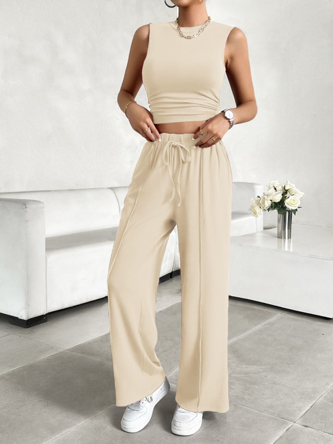 BELLA Trendsi mock neck sleeveless top and drawstring pants set shown on a model, featuring a stylish, casual outfit.
