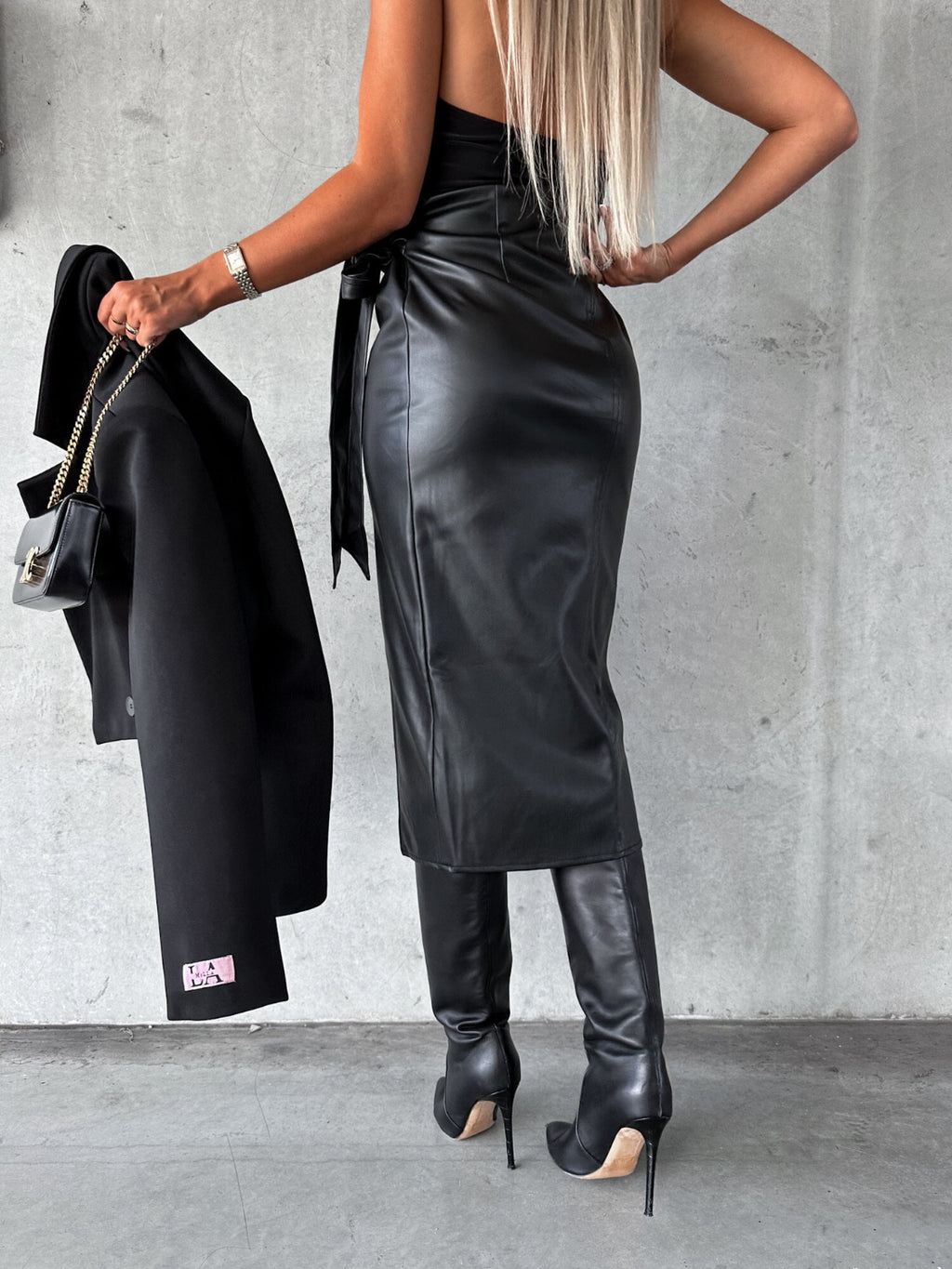 BELLA tied high waist skirt from Trendsi featuring a stylish design with a fitted waist and flowing fabric.