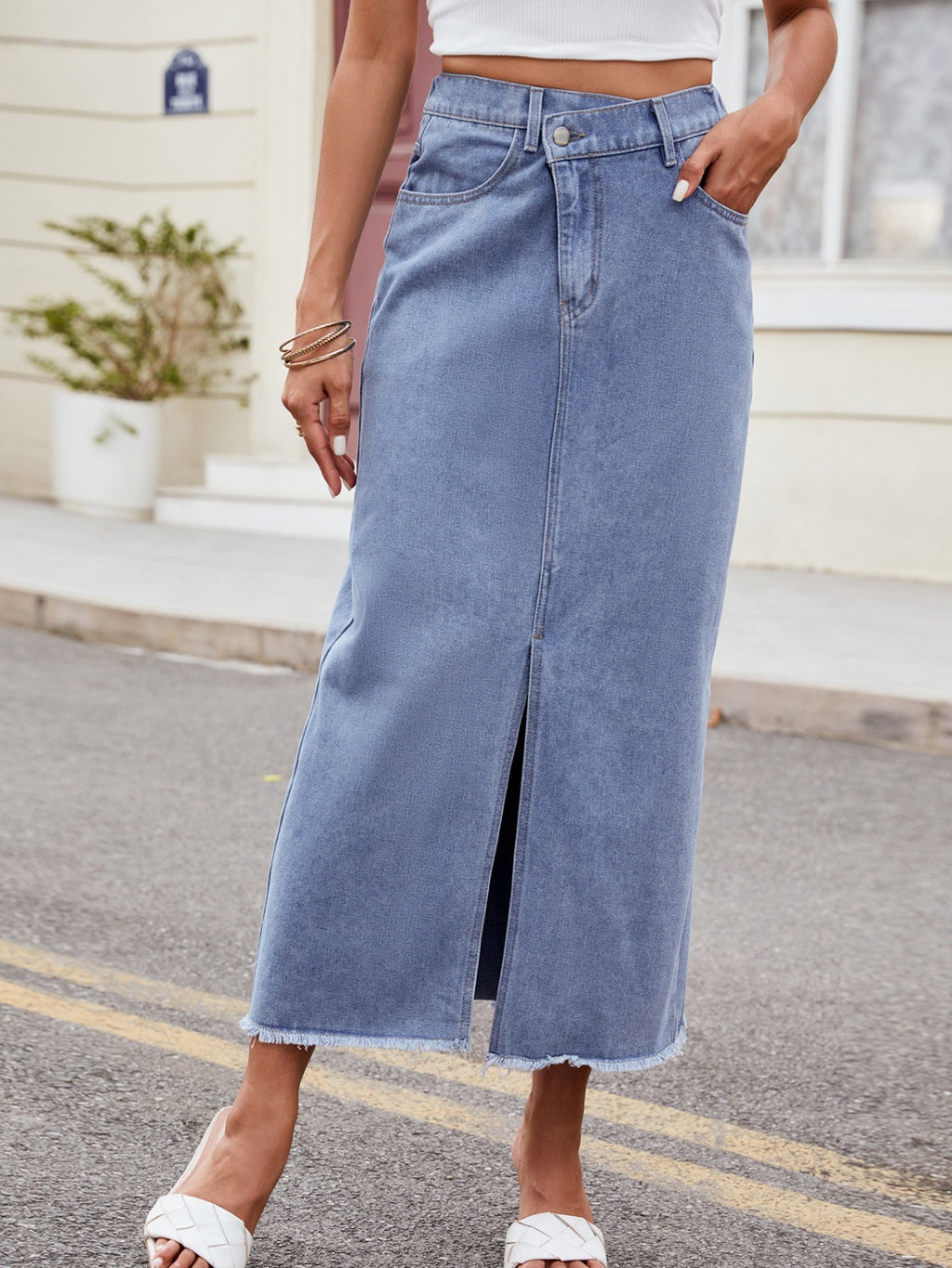 BELLA Trendsi asymmetrical waist denim skirt with a slit, showcasing its stylish design and trendy fit in a casual setting.